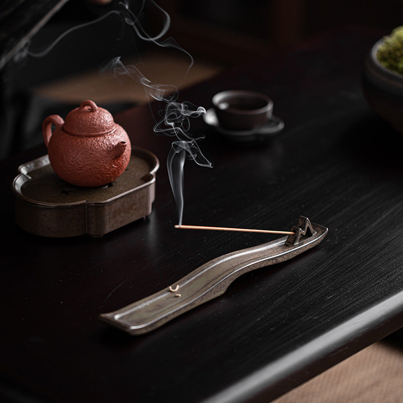 Incense holder displayed on a dark background